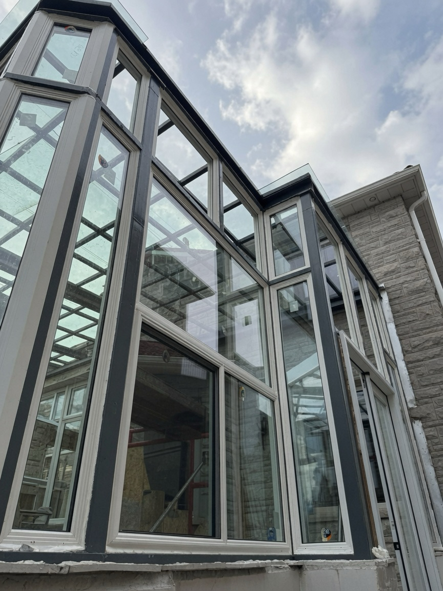 Floor-to-peak custom window wall built into a two-storey gable